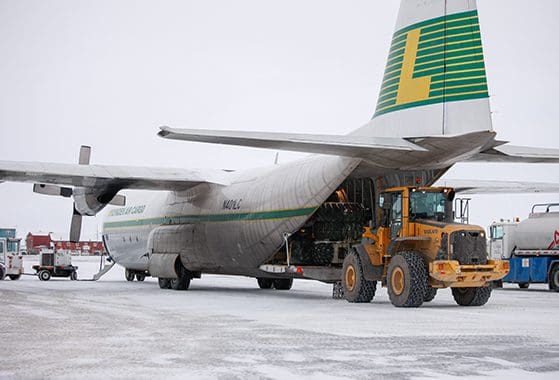 Loading supplies into an aircraft for expedited shipping.