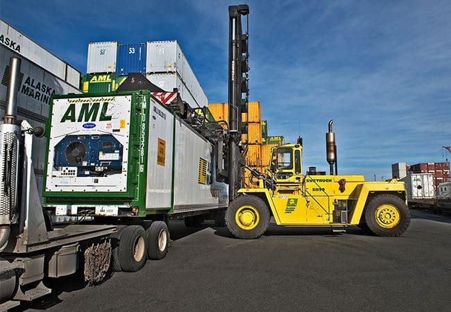 Loading temperature-controlled shipping container for delivery.